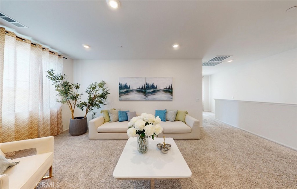 24320 Insignia Drive Menifee, CA 92584 - Photo 32 of 65 a living room with furniture and a potted plant