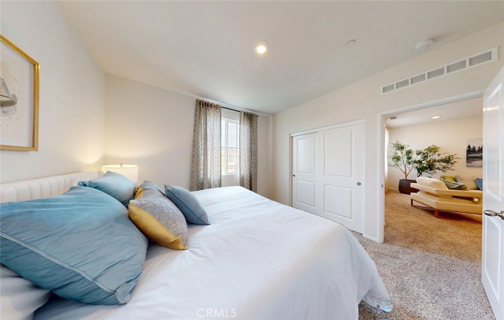 24320 Insignia Drive Menifee, CA 92584 - Photo 36 of 65 a bedroom with a large bed and a couch