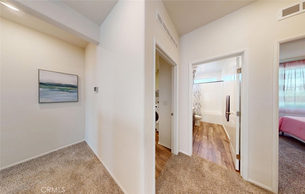 24320 Insignia Drive Menifee, CA 92584 - Photo 37 of 65 a view of a hallway with wooden floor and a living room