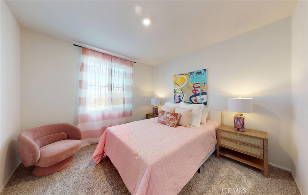24320 Insignia Drive Menifee, CA 92584 - Photo 38 of 65 a bedroom with a bed a couch and a large window