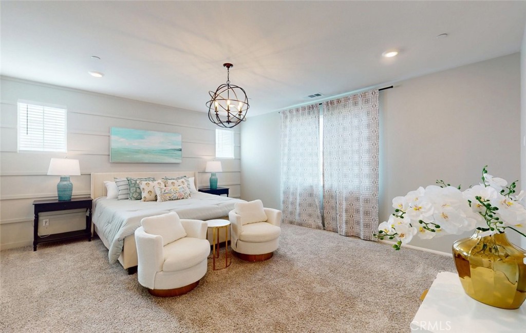 24320 Insignia Drive Menifee, CA 92584 - Photo 42 of 65 a bedroom with a bed and chandelier
