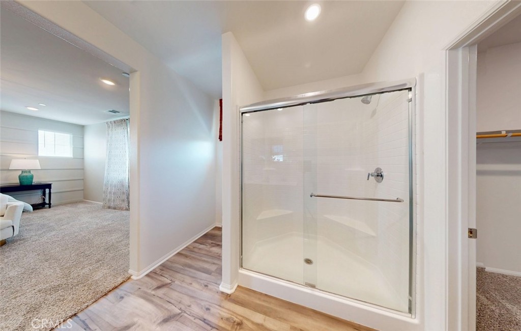 24320 Insignia Drive Menifee, CA 92584 - Photo 48 of 65 a bathroom with a glass shower door and a window