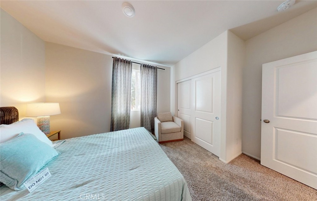 24320 Insignia Drive Menifee, CA 92584 - Photo 5 of 65 a bedroom with a bed and a large mirror