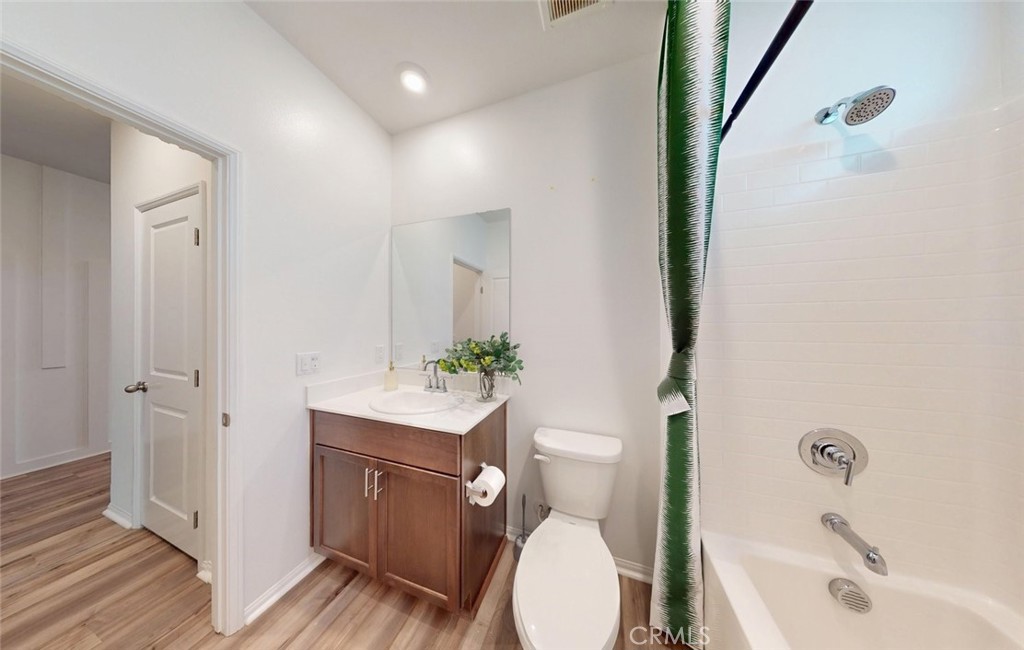 24320 Insignia Drive Menifee, CA 92584 - Photo 7 of 65 a bathroom with a sink a toilet a tub and shower