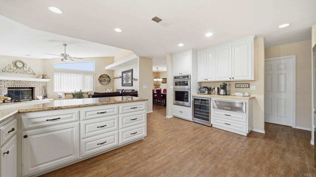 24586 Rutherford Road Ramona, CA 92065 - Photo 11 of 33 a kitchen with stainless steel appliances kitchen island granite countertop a stove and cabinets