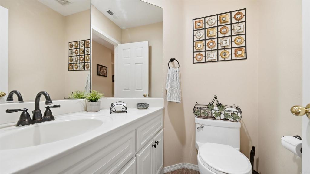 24586 Rutherford Road Ramona, CA 92065 - Photo 15 of 33 a bathroom with a toilet sink and mirror