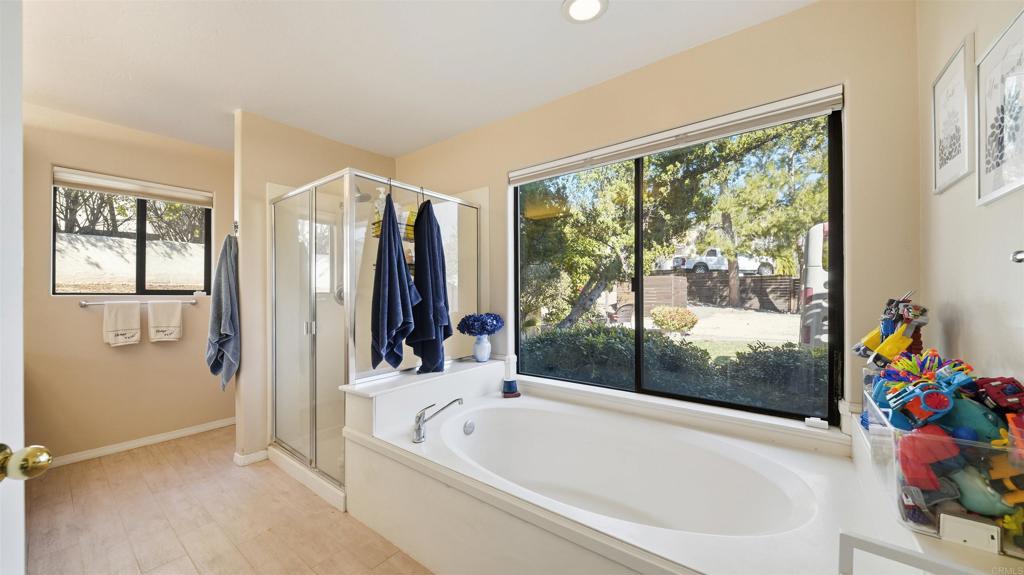 24586 Rutherford Road Ramona, CA 92065 - Photo 19 of 33 a bathroom with a bathtub and a shower