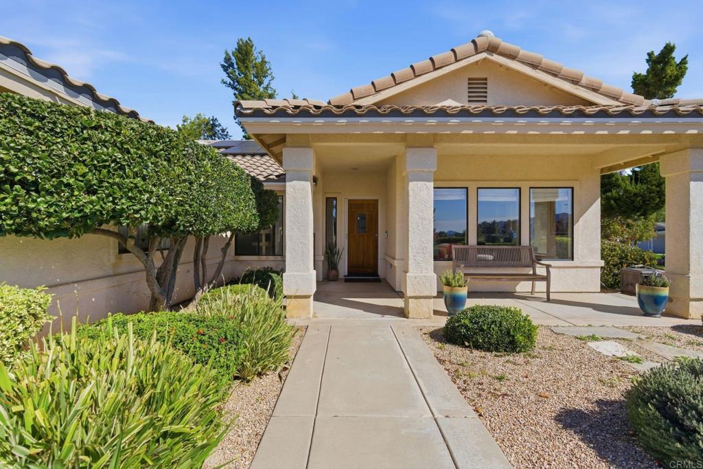 24586 Rutherford Road Ramona, CA 92065 - Photo 2 of 33 a view of a house with potted plants and a table and chairs