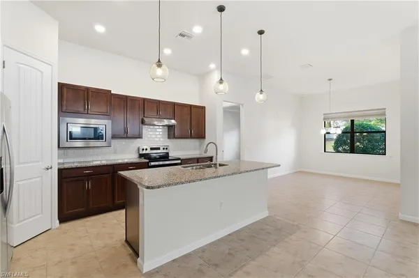 a large white kitchen with a large window