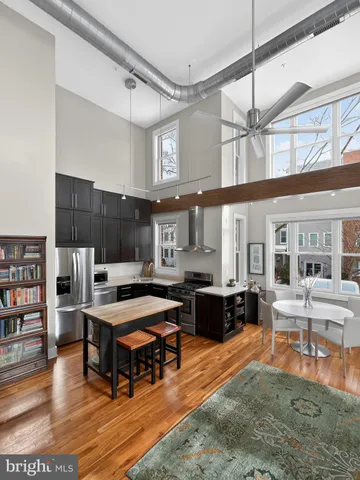 a living room with lots of furniture and kitchen view