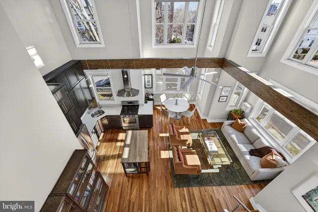 a view of a living room with furniture and wooden floor