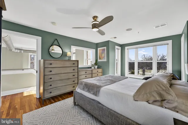 a bedroom with a bed and large window