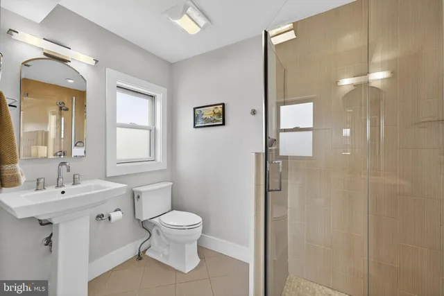 a bathroom with a toilet sink and shower