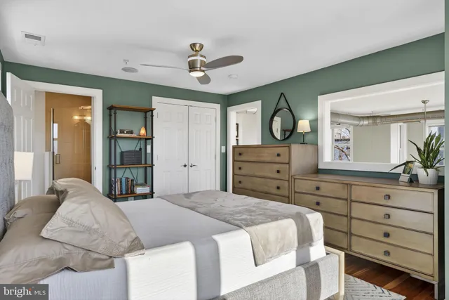 a bedroom with a large bed and a dresser