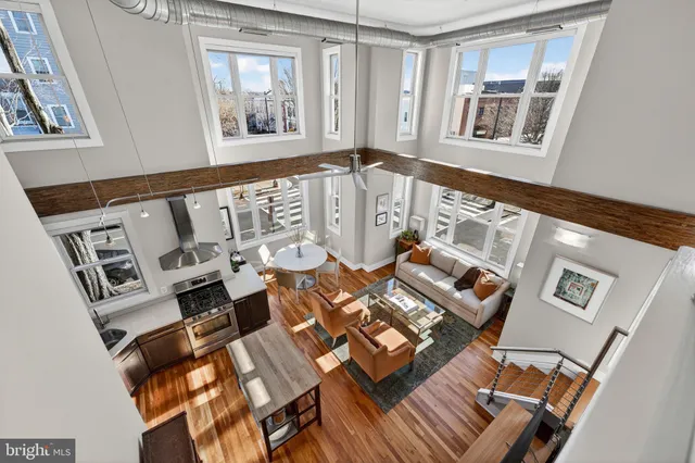 a view of a balcony with chairs and wooden floor