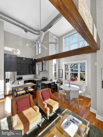 a living room with lots of furniture and kitchen view