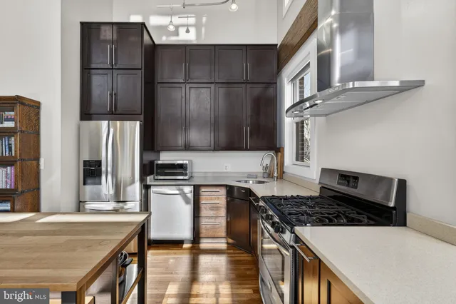 a kitchen with granite countertop a stove and a refrigerator
