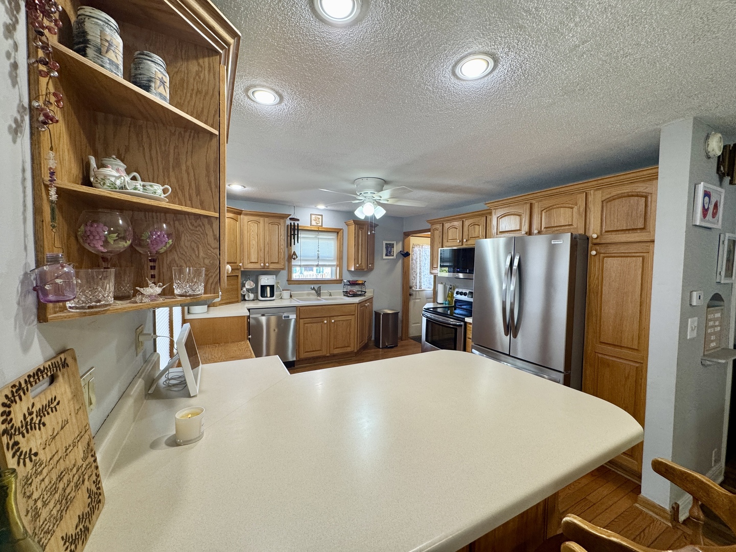 216 South Main Street Sheffield, IL 61361 - Photo 12 of 28 a large kitchen with stainless steel appliances wooden floor and a refrigerator