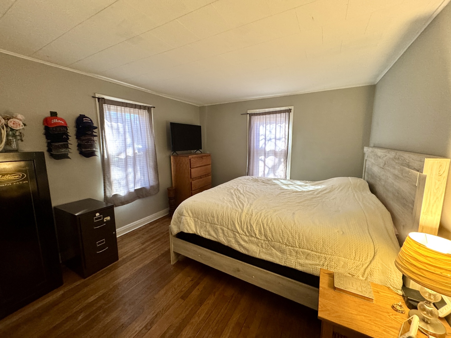 216 South Main Street Sheffield, IL 61361 - Photo 13 of 28 a bedroom with a bed and dresser with window