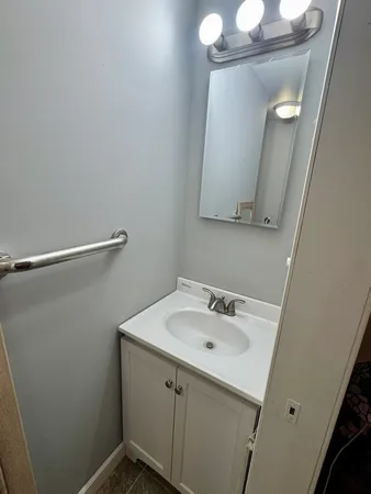 a bathroom with a sink and mirror