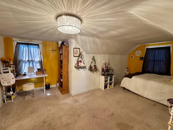 a bedroom with bed and window