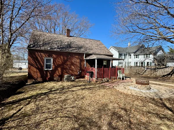 a front view of a house with a yard covered in snow