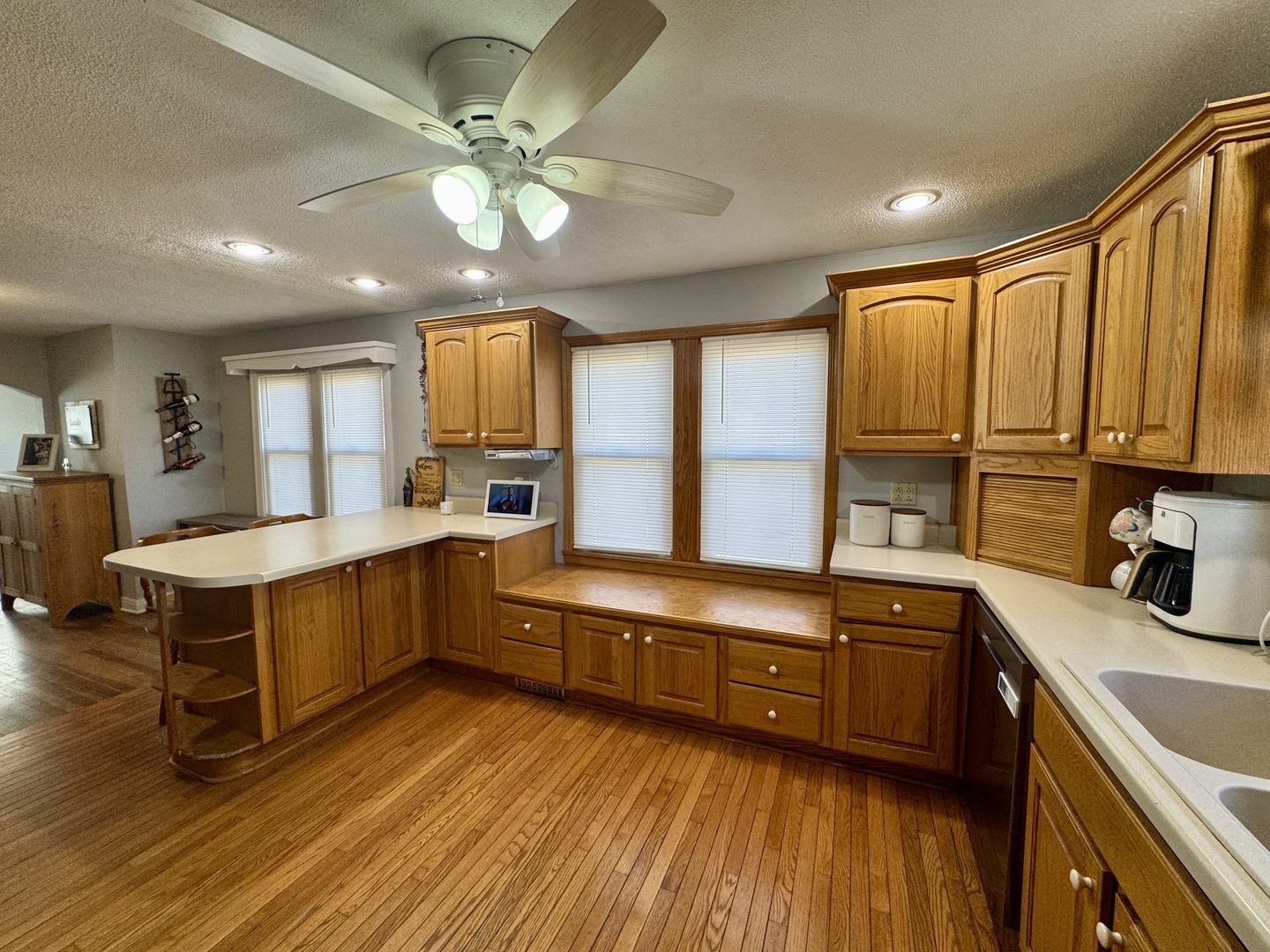 216 South Main Street Sheffield, IL 61361 - Photo 9 of 28 a large kitchen with a large window a sink dishwasher stove and refrigerator with wooden floor