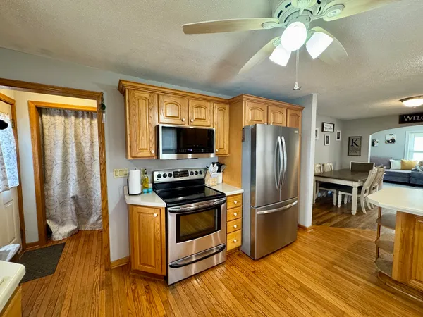 a kitchen with stainless steel appliances granite countertop a refrigerator microwave and stove top oven