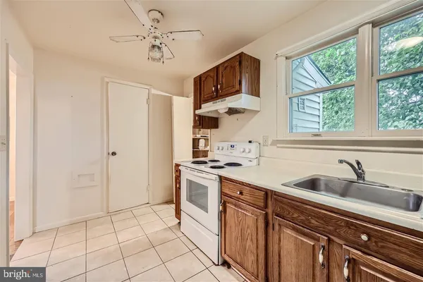 a bedroom with a bed a flat screen tv and dresser