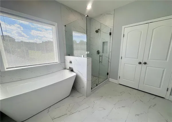 a spacious bathroom with a bathtub and a shower