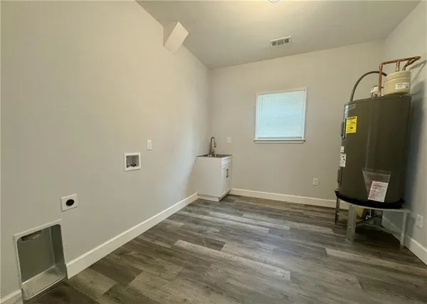 a view of a workspace with furniture and wooden floor