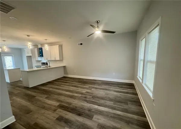 a view of a kitchen with a sink and cabinets