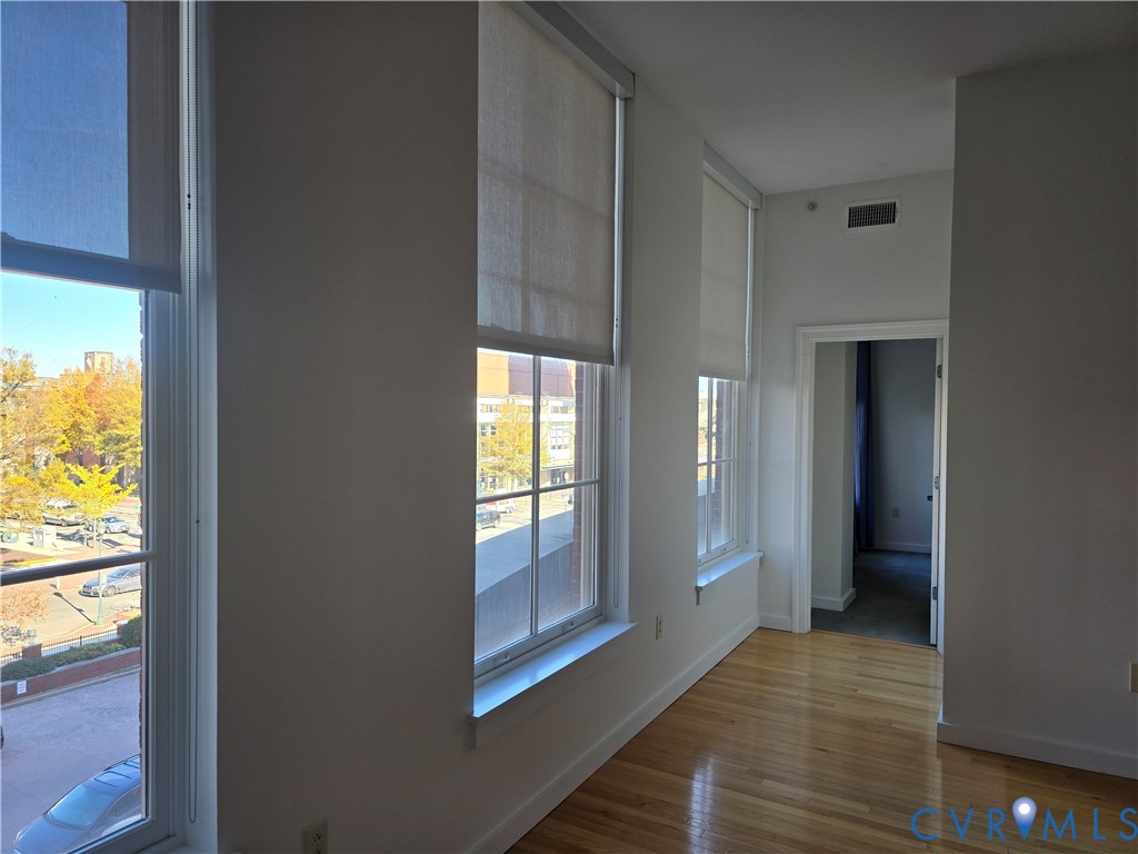 230 North 6th Street, Unit U318 Richmond, VA 23219 - Photo 13 of 24 a view of an empty room with glass door and wooden floor