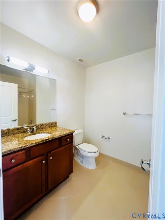 230 North 6th Street, Unit U318 Richmond, VA 23219 - Photo 16 of 24 a bathroom with a granite countertop sink a toilet and a mirror