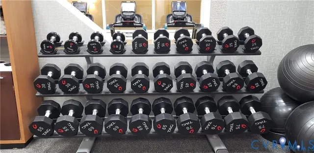 a kitchen with stainless steel appliances granite countertop a stove a sink a refrigerator and a dining table