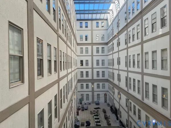 a kitchen with stainless steel appliances granite countertop a refrigerator a sink and wooden floor