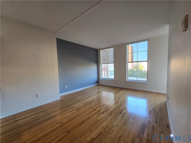 a view of wooden floor and windows in a room