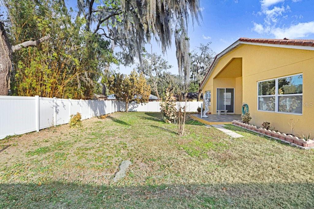 2412 Durant Road Valrico, FL 33594 - Photo 23 of 26 a backyard of a house with table and chairs