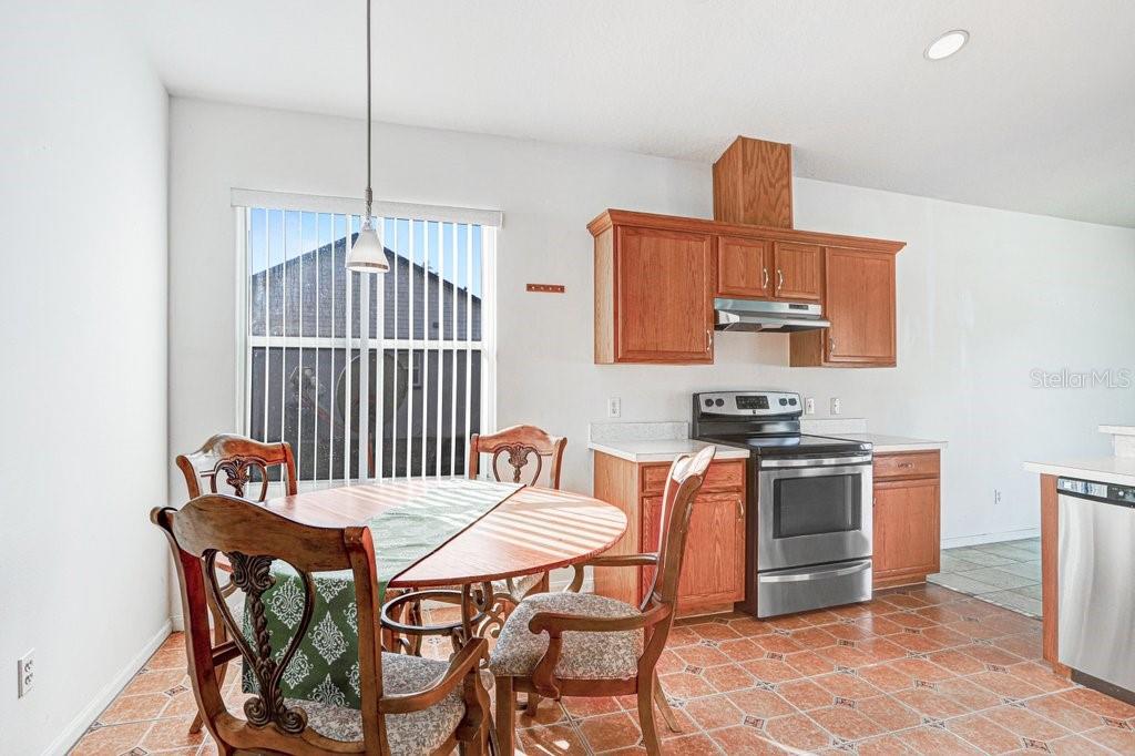2412 Durant Road Valrico, FL 33594 - Photo 7 of 26 a kitchen with stainless steel appliances a stove a table and chairs