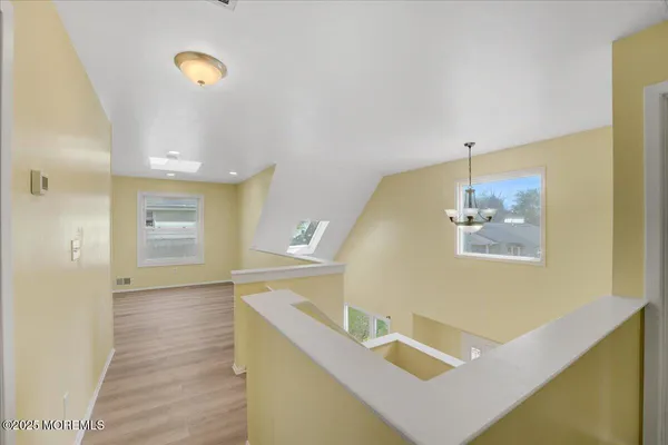 a view of hallway with wooden floor