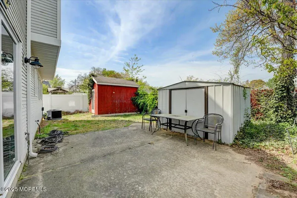 a view of backyard with outdoor seating and garage