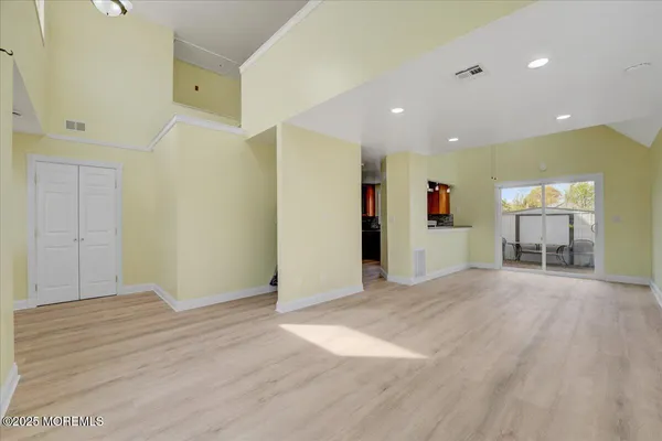 a view of empty room with wooden floor