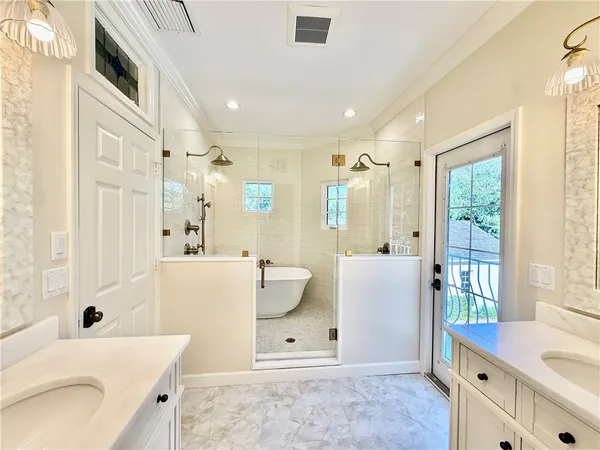 a bathroom with a tub sink and mirror