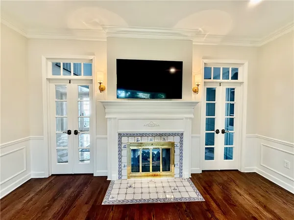 a living room with a fireplace and a flat screen tv