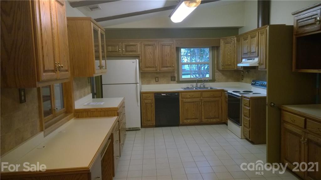 6800 Stoney Ridge Road Matthews, NC 28104 - Photo 6 of 15 a kitchen with a sink a stove and refrigerator