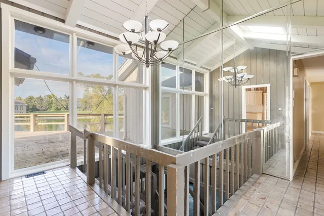 a view of a room with wooden floor and windows