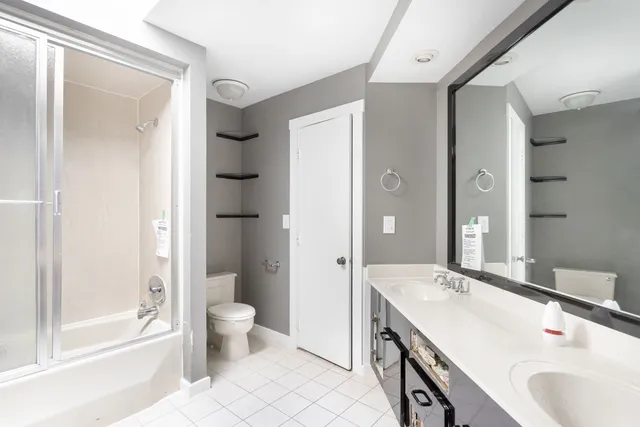 a spacious bathroom with a granite countertop sink toilet and shower