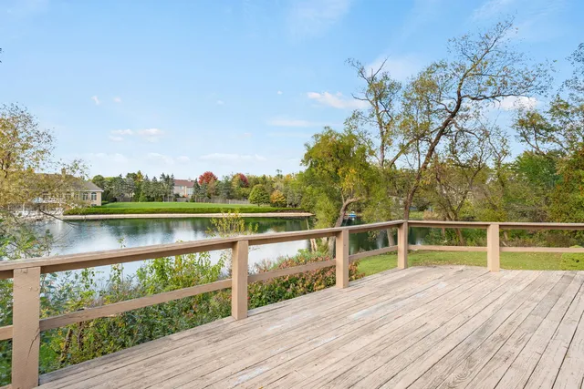 a view of mountain with wooden floor and fence