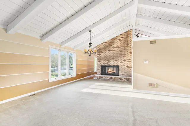 a view of an empty room with a fireplace