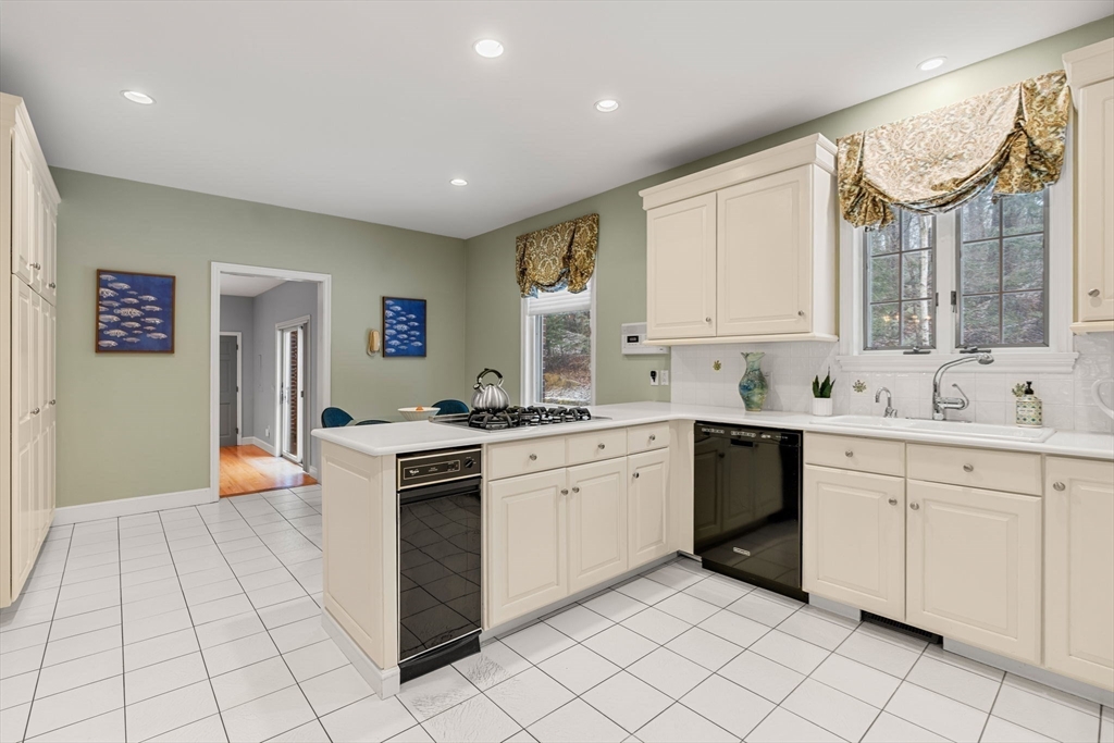 3 Stone Road Boxford, MA 01921 - Photo 11 of 40 a kitchen with white cabinets appliances and a window